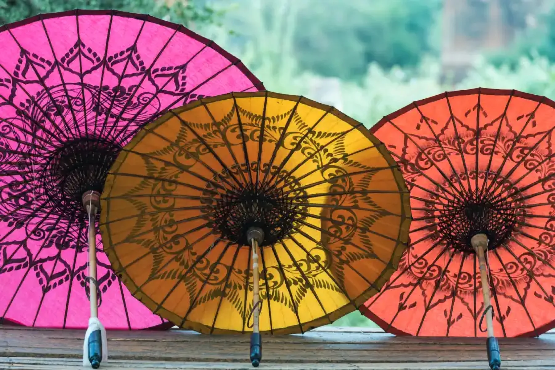 Painted paper parasols in pink, gold and red
